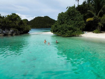 Aerial view of travelers in a lagoon, Wayag Archipelagio, West Papua, Indonesia