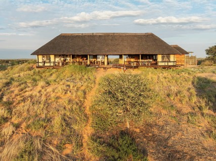 The main building of the Ta Shebube Rooiputs Lodge in the Kalahari Desert during the rainy season