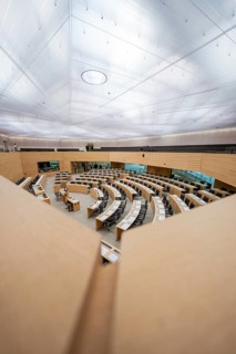 Modern hall, ready for duty with curved tables under a glass dome, state parliament of