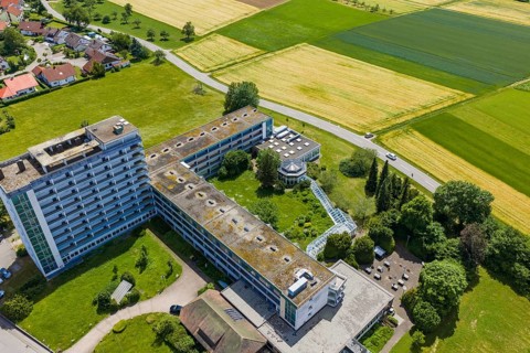 Complex of large-format buildings surrounded by green spaces and fields, Wart, Altensteig, Germany