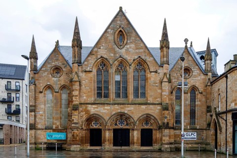 Triple gabled sandstone facade of Govan and Linthouse Parish Church, a Gothic revival building at