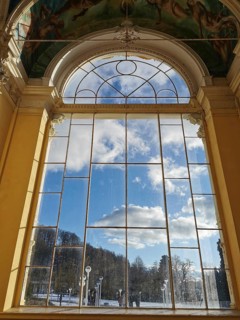 Large window with a view of the sunny sky and the surrounding landscape, Marianske Lazne, Maxim