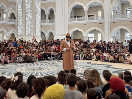 Dozens of Muslim children participate in indoor entertainment event inside a grand mosque during