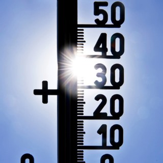 Thermometer shows heat in blazing sun and cloudless sky, symbolic image, summer 2026, Witten, North