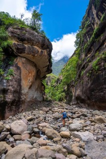 Female hiker in the Tugela Gorge or Tugela Gorge in the riverbed, Drakensberg National Park,