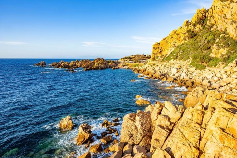 Landscape of the coastline with blue water at Costa Paradiso on a sunny day at evening, Sardinia,