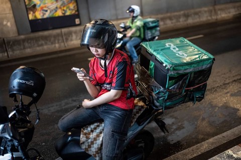 Bangkok, Thailand. August 18th 2026. Grab motorcycle delivery drivers in central Bangkok, the ride