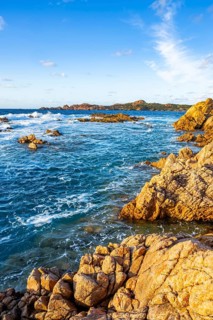 Landscape of the coastline with blue water at Marinedda Coast on a sunny day, Sardinia, Italy