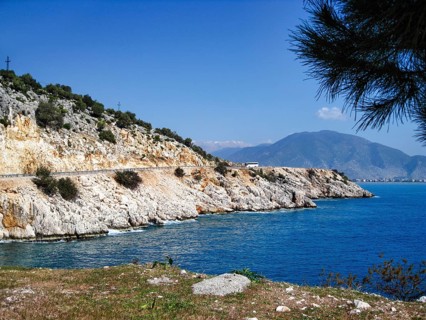 Picturesque coastal road on the Mediterranean Sea, steep rock walls, deep blue sea, bay, rugged
