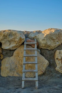 Wooden ladder on large, irregular rocks against blue sky, marina, Evrenseki, Manavgat, Antalya,