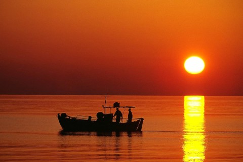 Greece - Crete - fishing boat in front of sunset, Crete, Greece