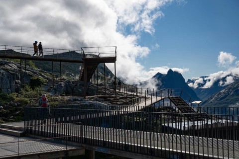 Visitors on viewing platform, Romsdalsgondolen mountain station, surrounded by majestic mountains
