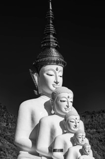 Five-headed Buddha statue, black and white photo, Wat Phra That Sorn Kaew Buddhist temple complex,