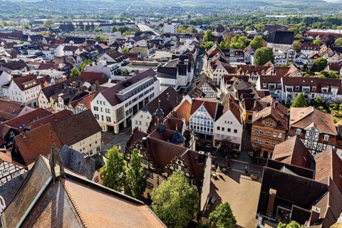 Panoramic aerial view of an old town with half-timbered architecture and red roofs, view of the