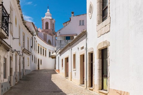 Altstadtgasse with the bell tower of the Igreja de Santo António (Church of St Anthony), Lagos,