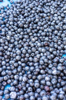 A close-up view of fresh, ripe blueberries with a rich dark color at a market