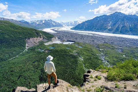 Young man enjoying the view, view of impressive mountain landscape with Matanuska glacier and