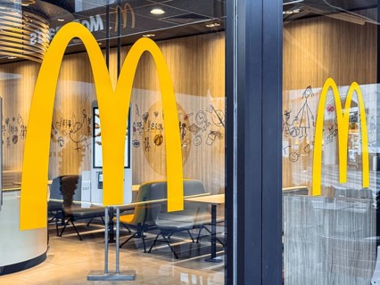 Turkiye, Antalya - 12.03.2025: McDonalds logo. Window door large yellow arches, symbolizing the