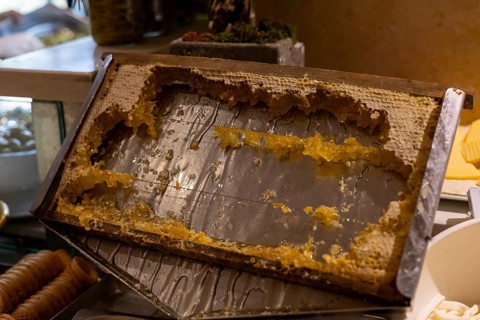Guests enjoy sampling fresh honeycomb at a hotel in Turkiye. The honey, harvested from local hives,