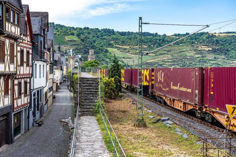 Freight train, in the Upper Middle Rhine Valley, runs directly in front of the residential