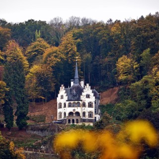 Listed, late historicist villa with stepped gable above the banks of the Rhine in autumn, Remagen,