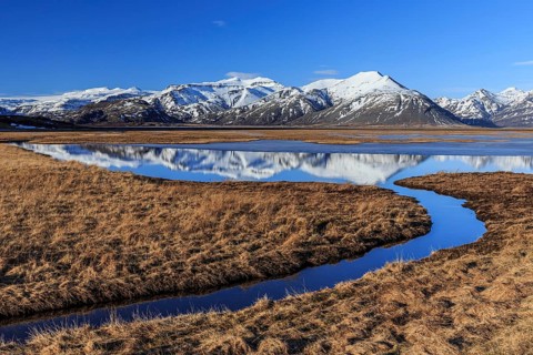Mountains reflected in moor, winter, sunny, Skaftafell National Park, Iceland