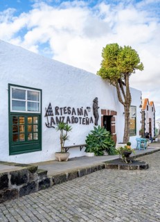 Souvenir shop, white house with green doors and shutters, Plaza de la Constitución, Teguise,