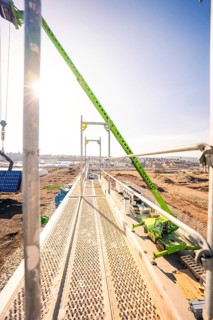 Sunny construction site with scaffolding and clear blue sky in the background, PV installation at