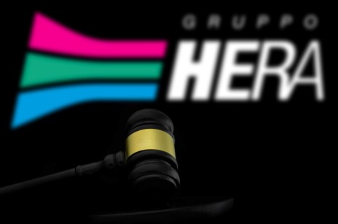 Court gavel in front of the Gruppo hera logo. Hera spa is a multiutility company
