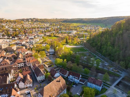 Panoramic view over a town with houses, parks, a river and surrounding hills, Nagold, Black Forest,