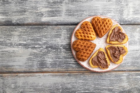 Homemade waffle with chocolate butter on a gray wooden background. top view, flat lay, copy space