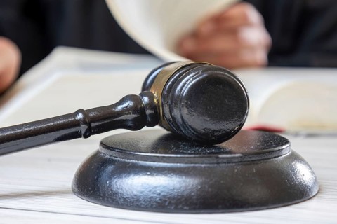 Symbolic picture court hearing: close-up of a judge's hammer