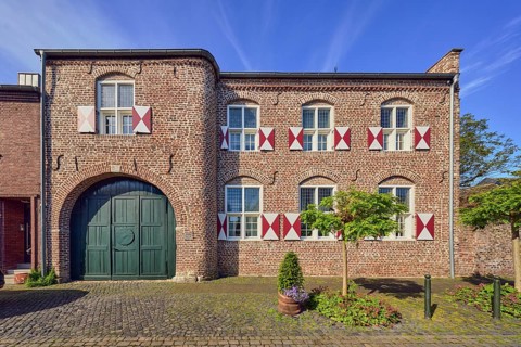 House Wachtendonk, old town center, historic brick building, façade with windows, shutters and wall