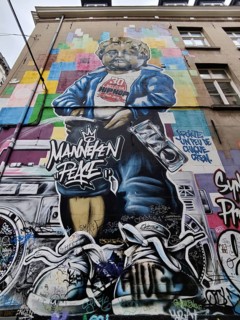 Museum GardeRobe Manneken Pis with street art mural Manneken Peace, Brussels, Belgium