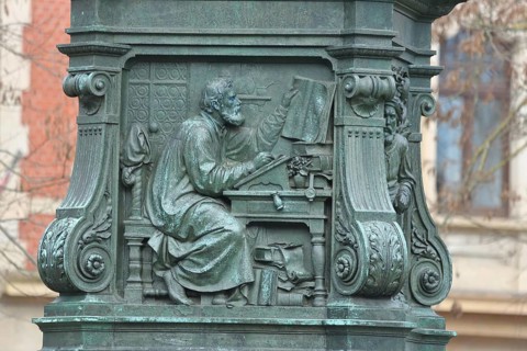 Relief of Martin Luther translating the Bible at a desk, Bible, Luther Memorial, Eisenach,