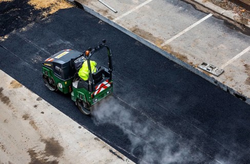 Tandem roller compacts an asphalt surface following road repair, Schöneberg, Berlin, Germany