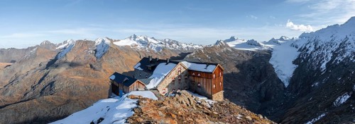 Snowy mountain landscape, mountain hut Ramolhaus in autumn with snow, in the evening light, view of