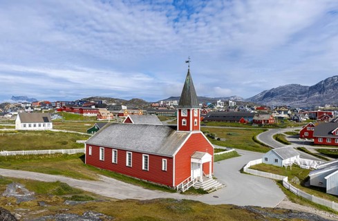 Typical architecture of Greenland capital Nuuk with colored houses located near fjords and icebergs