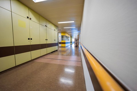 Hospital corridor with yellow-brown wall cabinets and modern equipment, Nagold Hospital of the