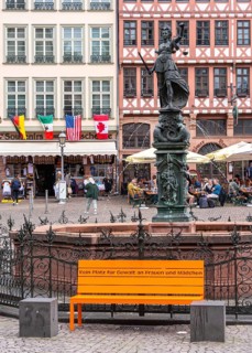 No room for violence against woman and men, orange-colored bench with social slogan on the