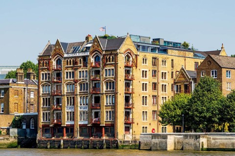 The Venetian Gothic facade of Oliver's Wharf, a converted Victorian tea warehouse now riverside