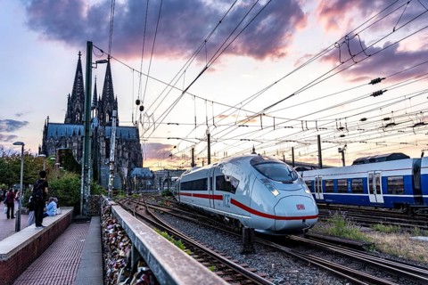 The Hohenzollern Bridge across the Rhine, railway bridge, ICE train leaves the main station, heads