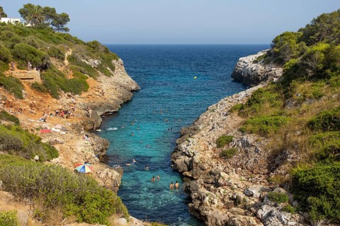 People bathe in Cala Muta Bay in Majorca, Cala Muta, Porto Cristo, Majorca, Spain