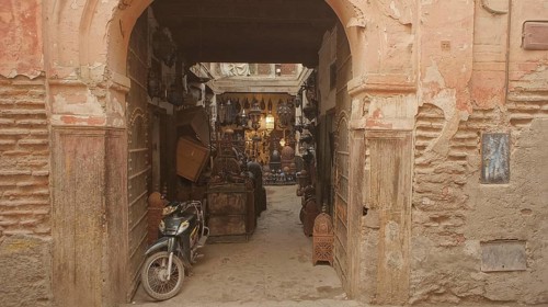 An arch in the old town leads to a Moroccan courtyard in the medina full of antique furniture, with