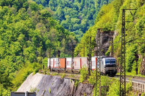 Goods train travelling on the winding Geislinger Steige railway line. Landscape along the railway