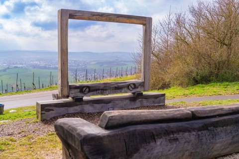 Large wooden frame with bench and view of a hilly landscape, Großbottwar, Ludwigsburg district,