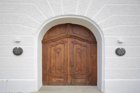 Brown portal with wood carving, front door and gate, castle, Günzburg, Bavaria, Germany