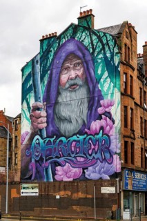 Street art mural depicting the wizard Merlin, said to have originated in Partick, painted on a