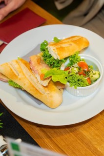 Baguette sandwich with ham and salad, served with cucumber and tomato, autumn creations, Cafe Kuh,