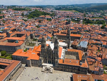 Breathtaking aerial view of a cathedral and red roofs over a historic city with hilly landscape,